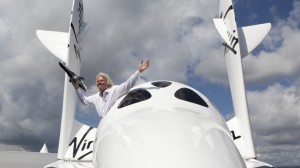 Sir Richard Branson in SpaceShipTwo holding a model of LauncherOne.